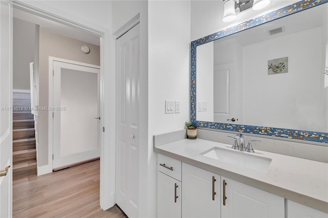 bathroom with vanity and hardwood / wood-style flooring