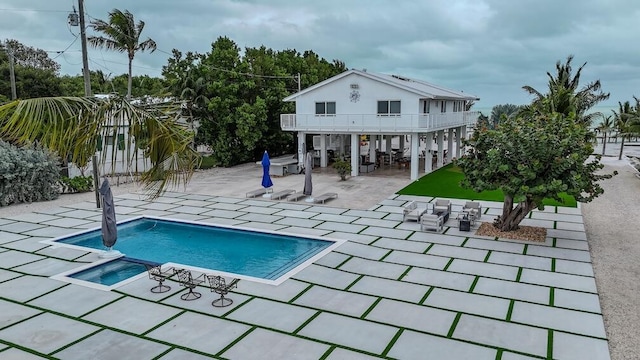 view of swimming pool featuring an in ground hot tub and a patio area