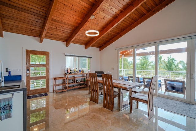 dining area featuring beamed ceiling, high vaulted ceiling, and wooden ceiling