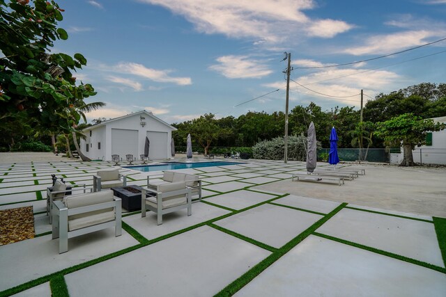 view of patio with an outbuilding and a community pool