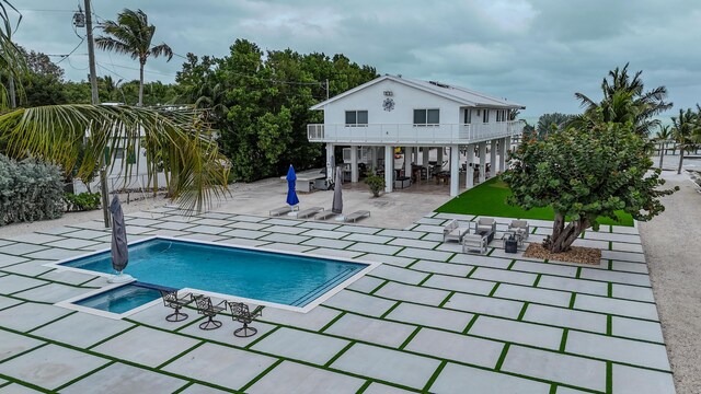 view of pool featuring an in ground hot tub and a patio area