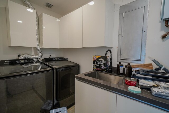 laundry area featuring cabinets and washer and clothes dryer