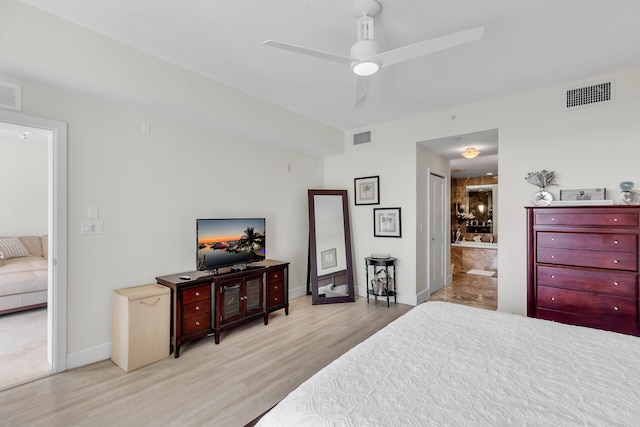 bedroom with light hardwood / wood-style flooring, ceiling fan, and ensuite bathroom