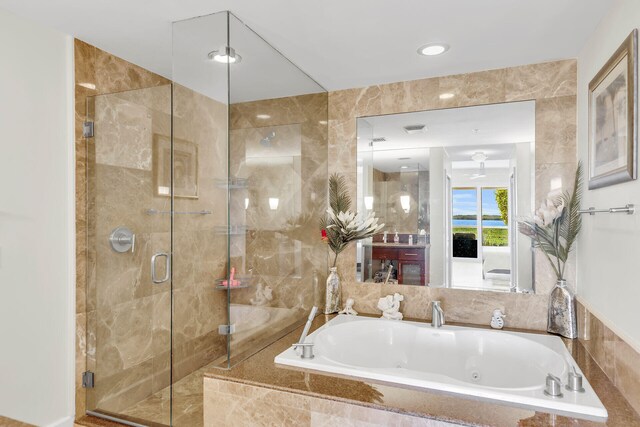 bathroom with plus walk in shower and tile walls