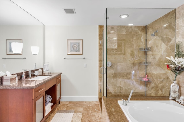 bathroom with vanity and independent shower and bath