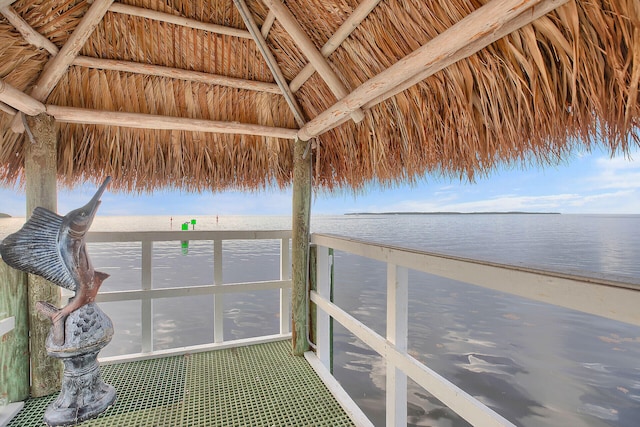 dock area featuring a view of the beach, a gazebo, and a water view