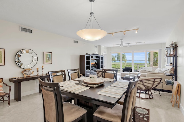 dining space featuring rail lighting