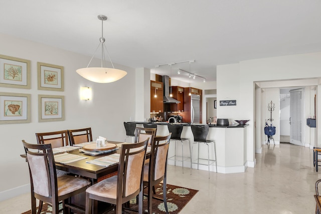 dining room featuring rail lighting