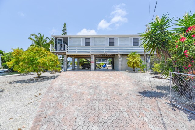 view of front of home featuring a sunroom and a carport