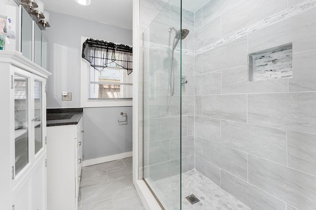 bathroom with vanity and tiled shower