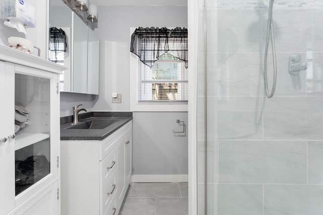 bathroom with vanity and tiled shower