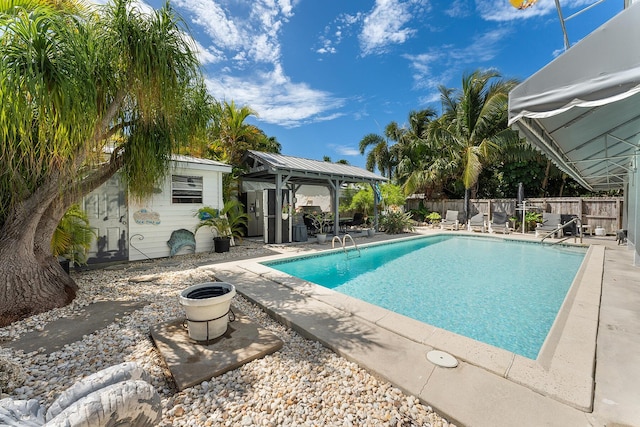 view of swimming pool with a gazebo, an outbuilding, and a patio