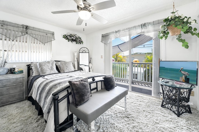 bedroom featuring ceiling fan, carpet flooring, a textured ceiling, and access to outside