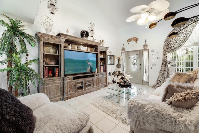 tiled living room featuring ceiling fan and high vaulted ceiling