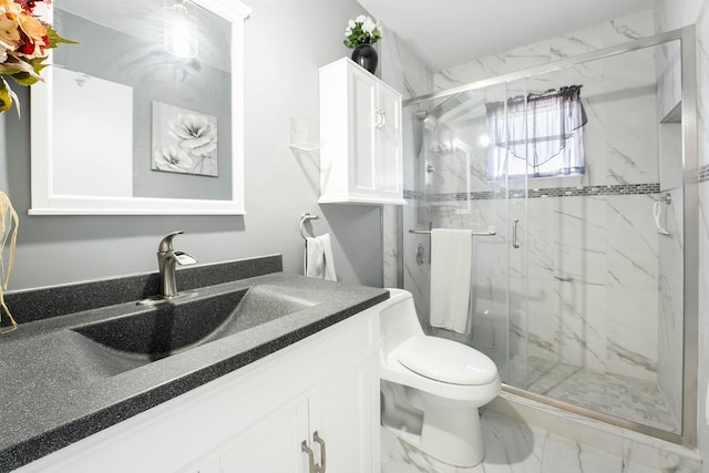 bathroom with vanity, toilet, and a shower with shower door