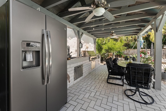 view of patio / terrace with exterior kitchen, ceiling fan, and grilling area