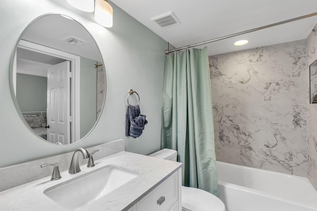 full bathroom featuring vanity, shower / bath combination with curtain, and toilet