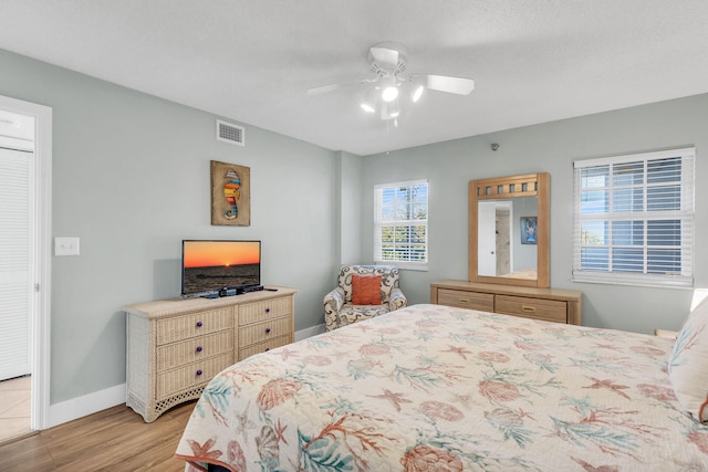 bedroom with ceiling fan and light hardwood / wood-style flooring