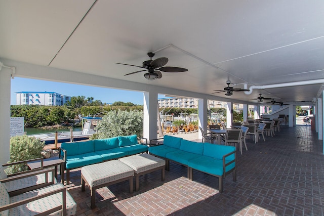 view of patio / terrace with ceiling fan, an outdoor living space, and an outdoor bar