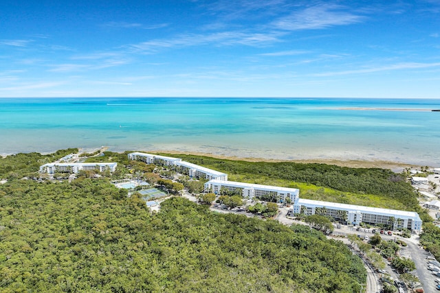 birds eye view of property featuring a beach view and a water view