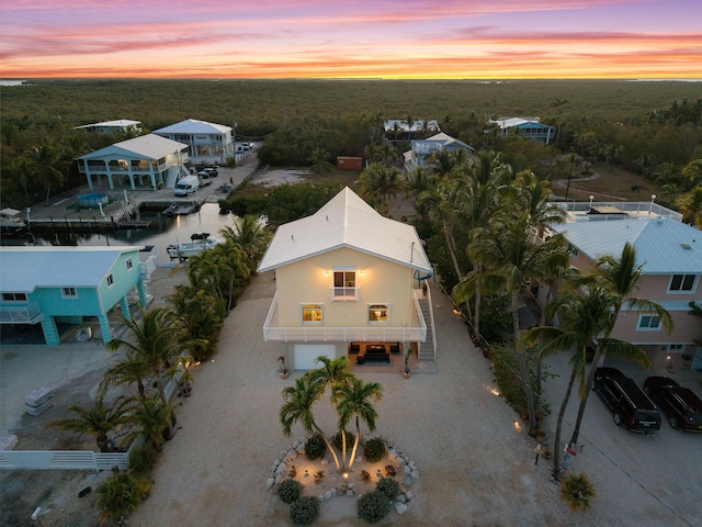 aerial view at dusk with a wooded view