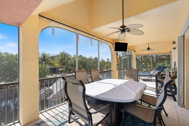 sunroom with a ceiling fan and a wealth of natural light