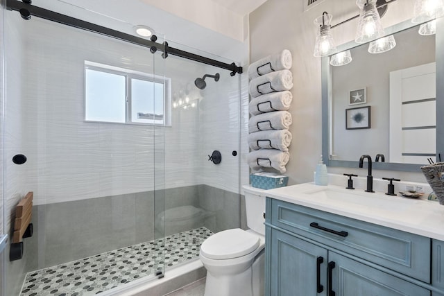 full bathroom featuring vanity, toilet, and a stall shower