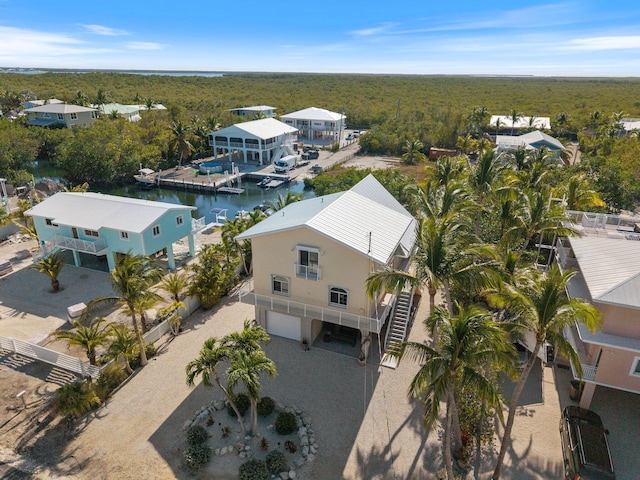 drone / aerial view with a water view and a wooded view