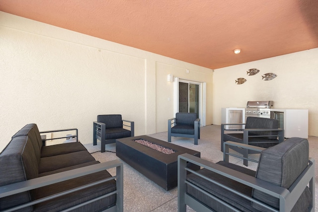 view of patio with an outdoor living space with a fire pit