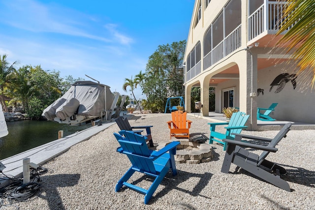 view of patio / terrace with a water view and an outdoor fire pit