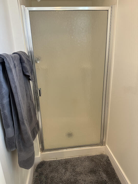 bathroom featuring an enclosed shower