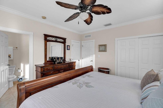 bedroom featuring light tile patterned floors, ornamental molding, a closet, and visible vents