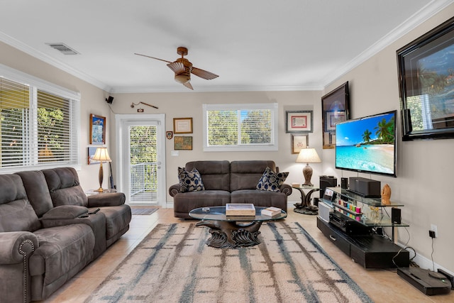 living area featuring ceiling fan, tile patterned flooring, visible vents, and crown molding