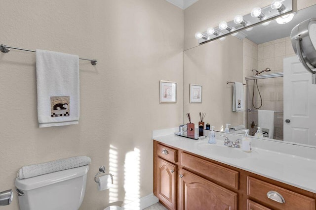 bathroom featuring toilet, a tile shower, and vanity