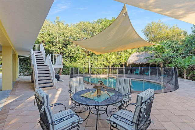 view of swimming pool with fence, stairway, a fenced in pool, and a patio