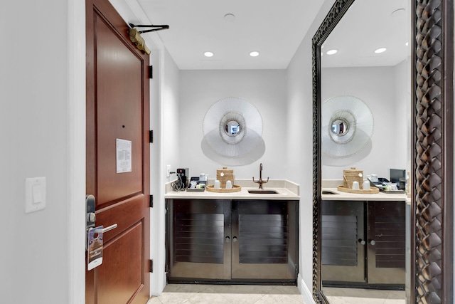 bar with light tile patterned floors and sink