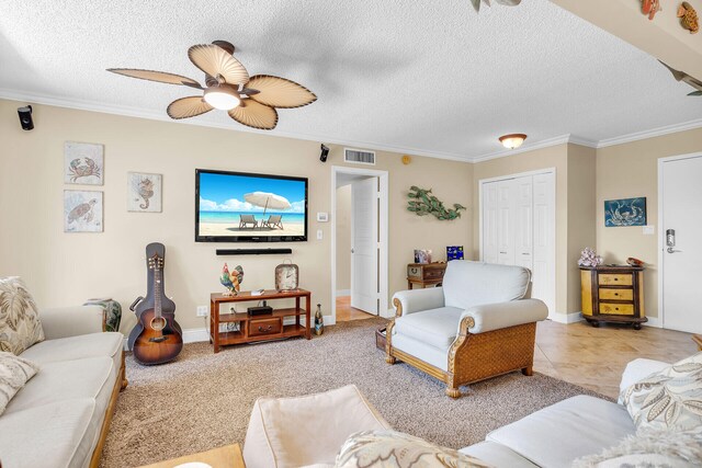 carpeted living room featuring ornamental molding, ceiling fan, and a textured ceiling