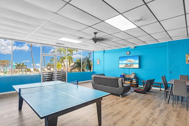 rec room featuring a drop ceiling and hardwood / wood-style floors