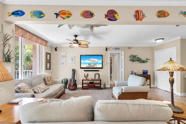 living room featuring ceiling fan, crown molding, and a textured ceiling