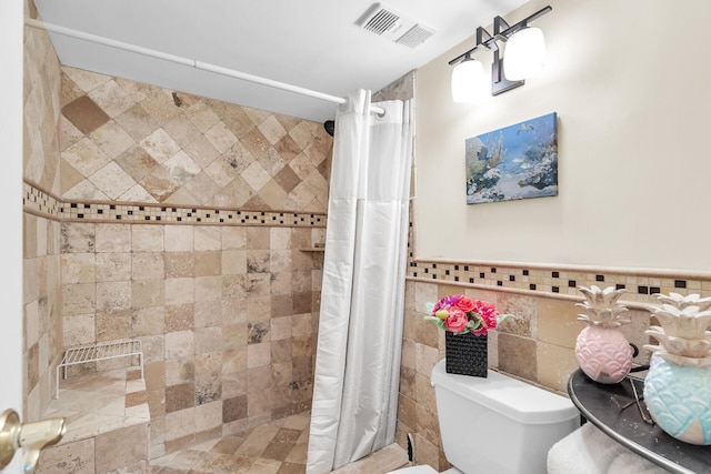 bathroom with walk in shower, tile walls, and toilet