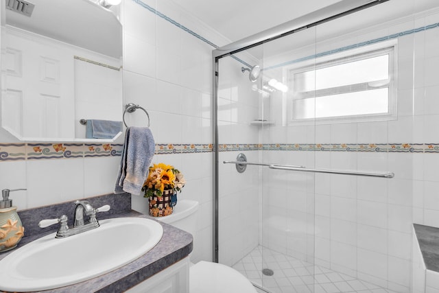 bathroom featuring ornamental molding, vanity, toilet, and an enclosed shower