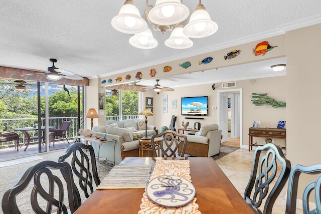 tiled dining space with crown molding, ceiling fan with notable chandelier, and a textured ceiling