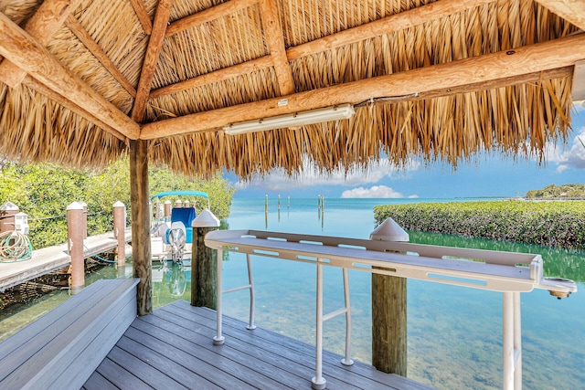 view of dock with a water view and a gazebo