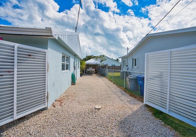 view of yard with central air condition unit and fence