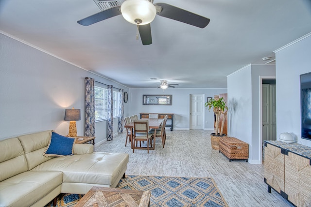 living area featuring a ceiling fan, crown molding, wood finished floors, and baseboards