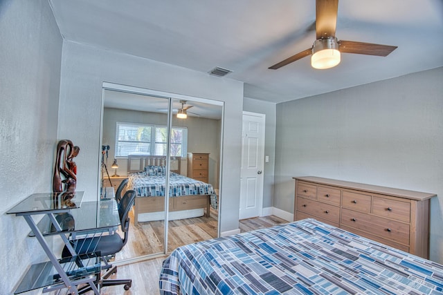 bedroom with a closet, ceiling fan, and light wood-type flooring