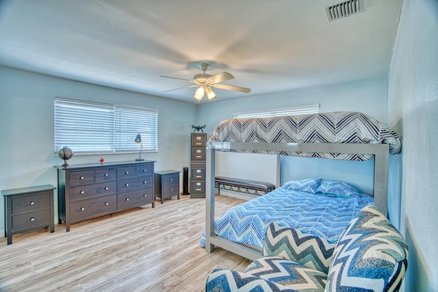 bedroom with light hardwood / wood-style flooring and ceiling fan