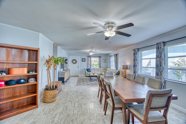 dining area with crown molding, light hardwood / wood-style flooring, and ceiling fan