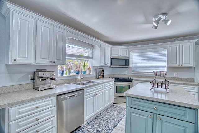 kitchen featuring sink, white cabinets, and appliances with stainless steel finishes