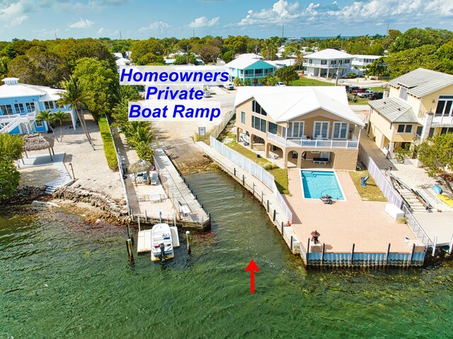 birds eye view of property with a water view